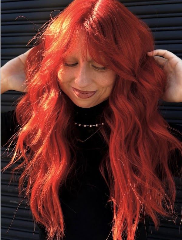 Bright copper red color with bangs at Ra'pôr Salon in Costa Mesa