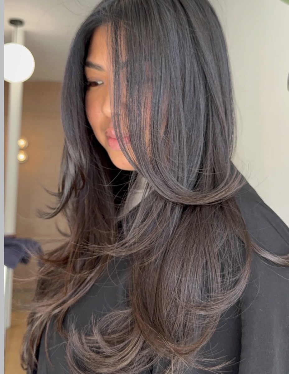 Long face framing layers on dark brunette hair, cut at Ra'pôr on East 17th Street, Costa Mesa