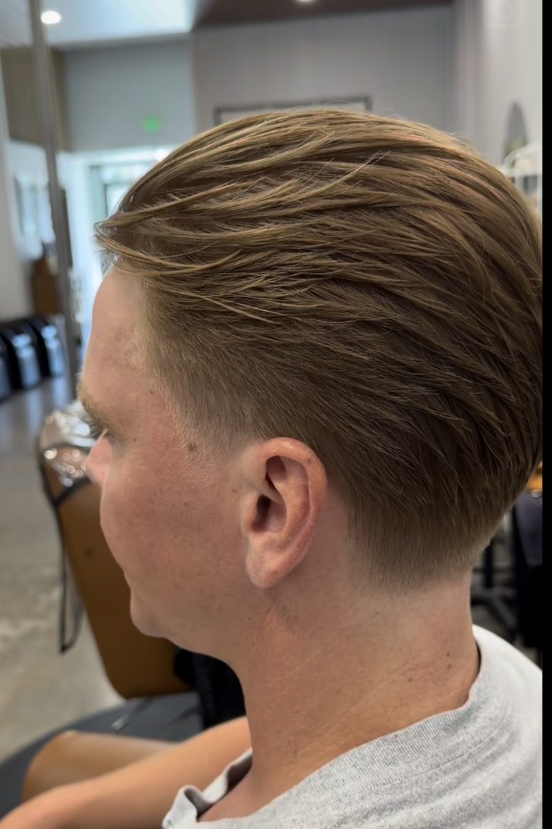 Slick back haircut with a clean taper, done at Ra'pôr Salon and Barber on Newport Blvd, Costa Mesa